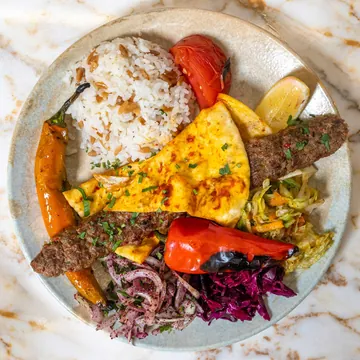 Adana kebab with rice and vegetables