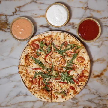Turkish pizza with rocket, cherry tomatoes and peppers